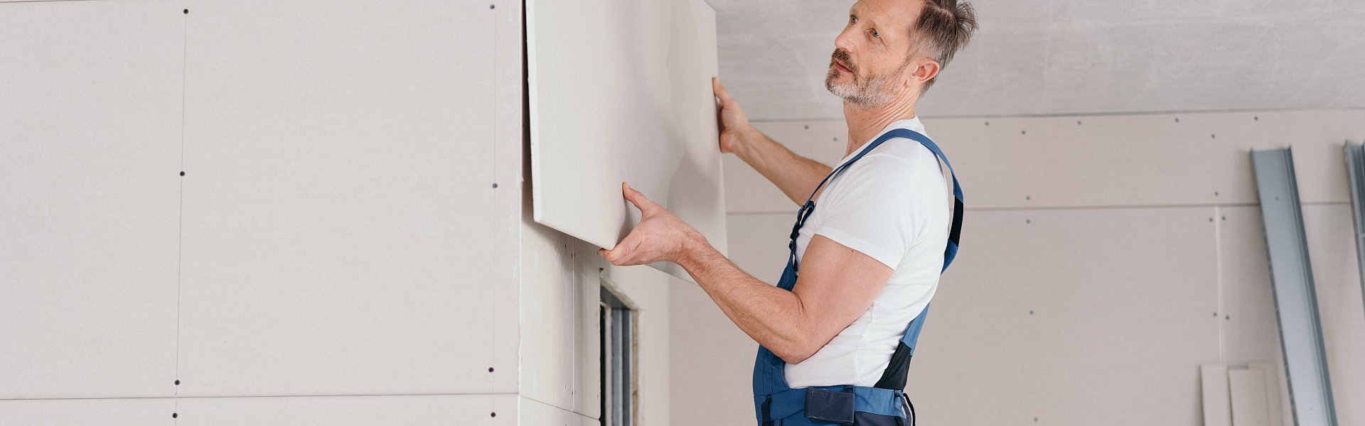 Frau befestigt Dämmwolle