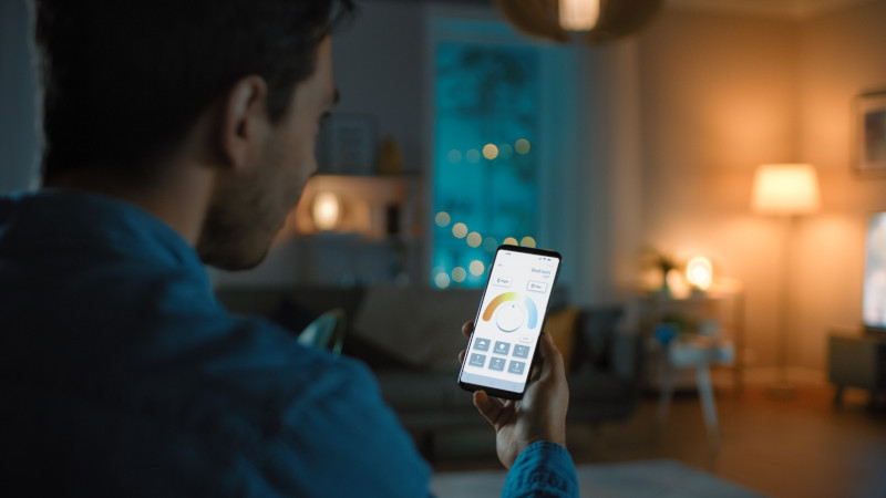 Mann steuert per App sein Smart Lighting System
